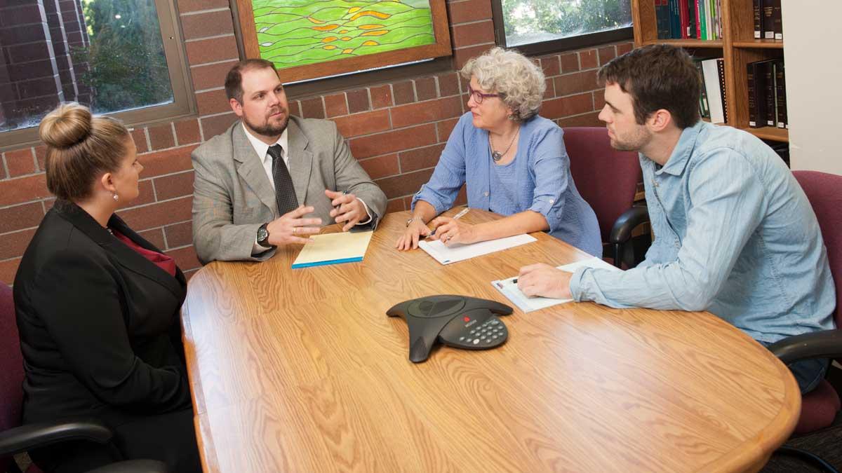 Law students meeting with clinic faculty.